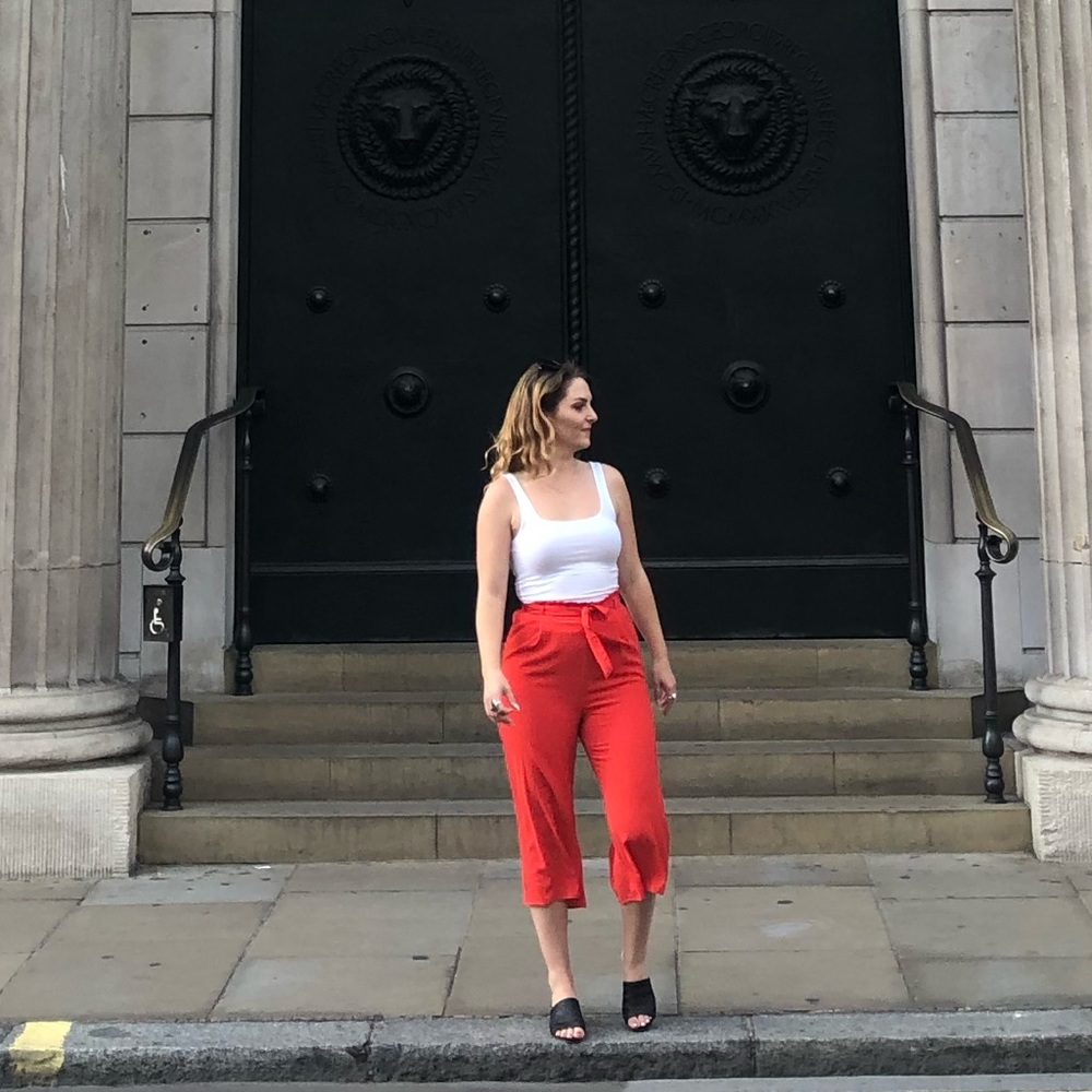 Orangey red high waisted cropped trousers with tie